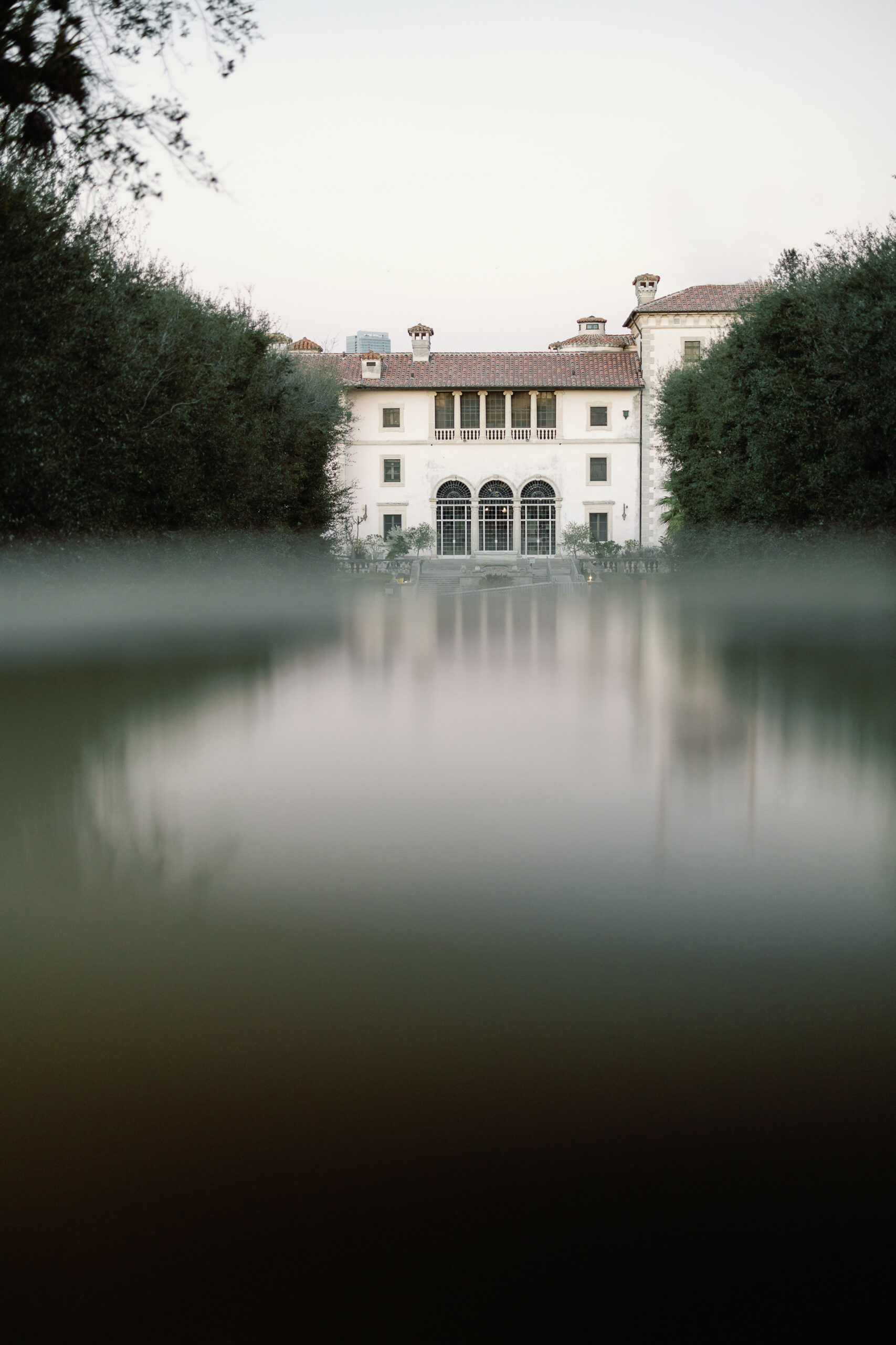 Vizcaya Museum exterior reflected in water at dusk