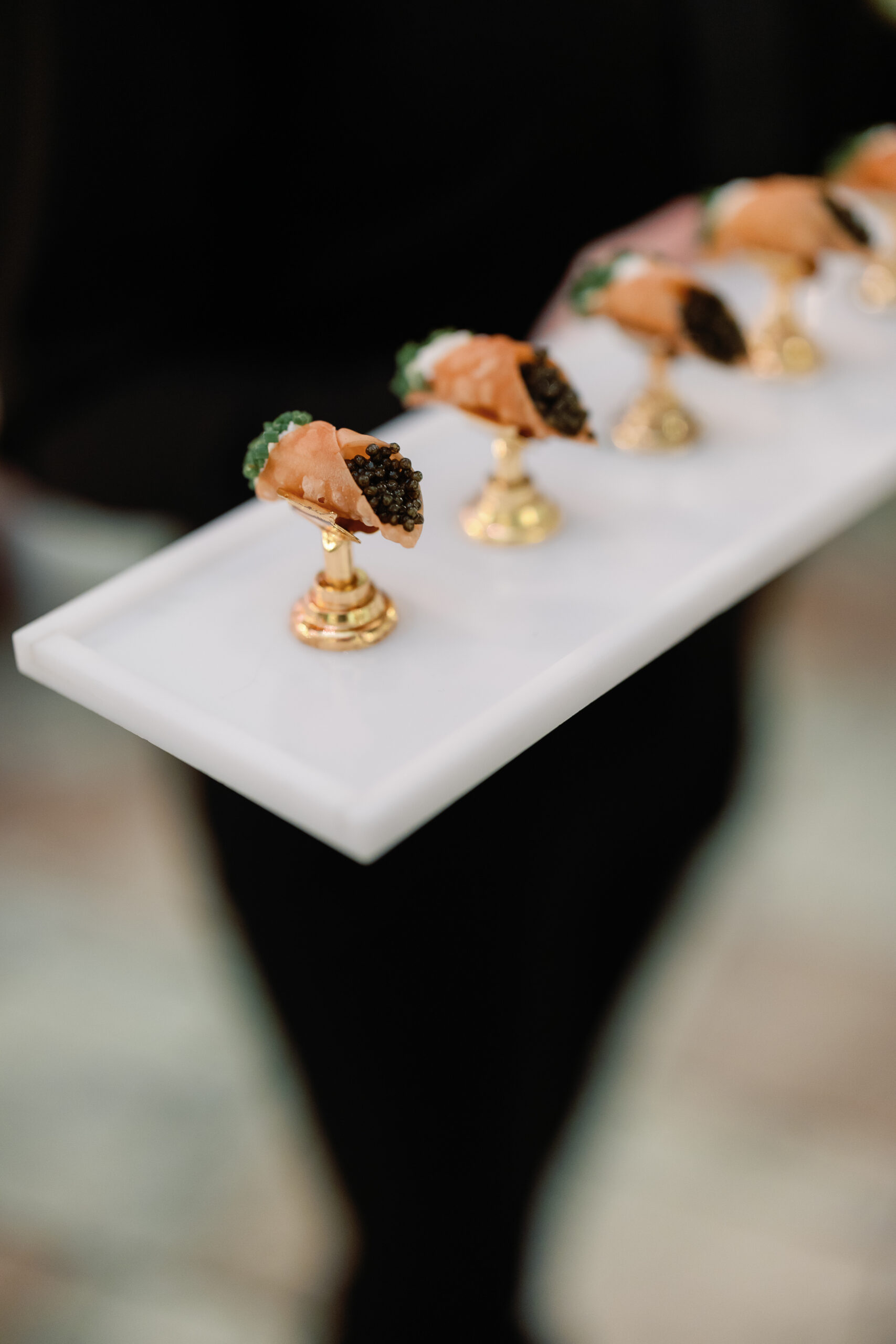 Caviar passed appetizers on marble tray at reception
