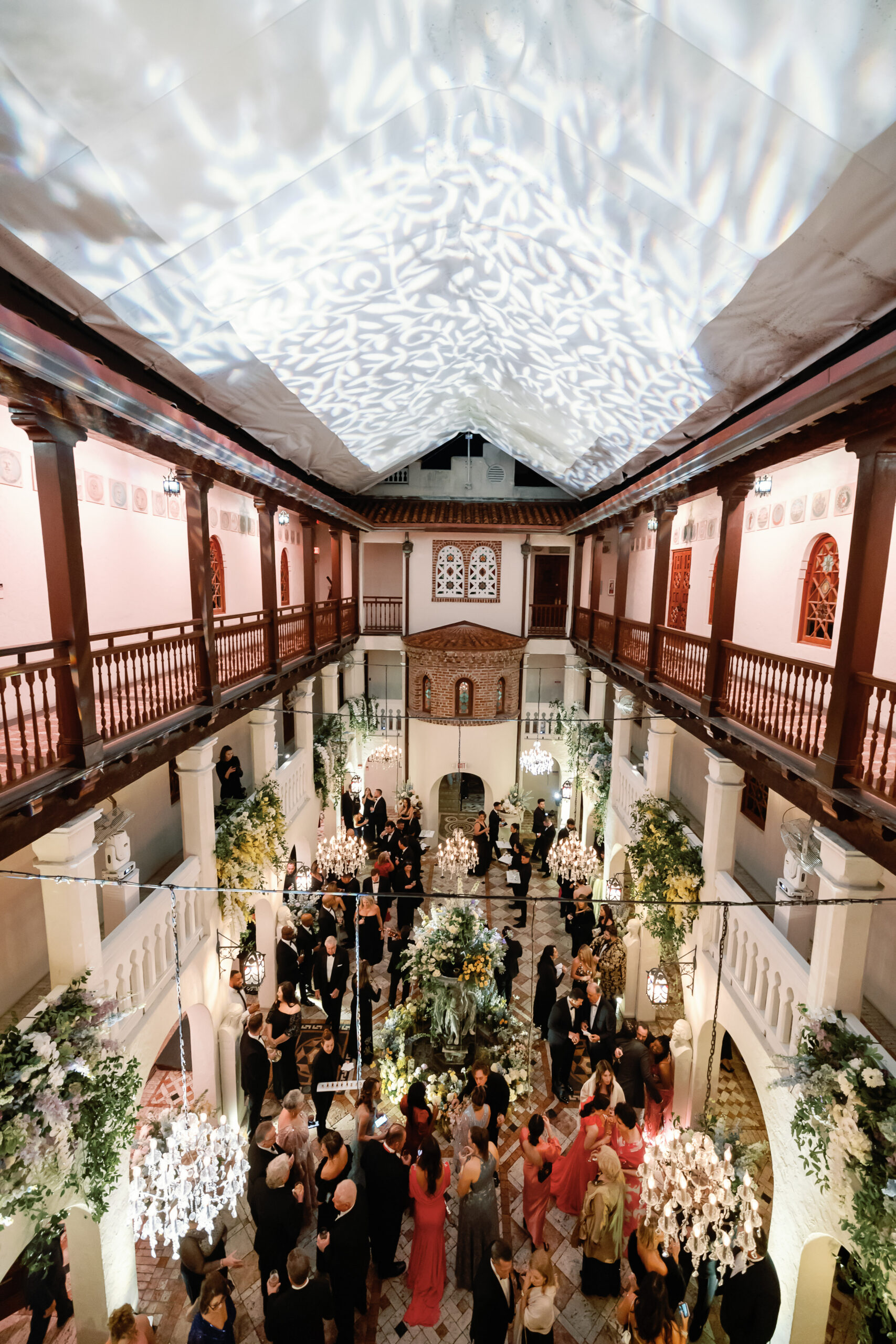 Overhead view of reception guests in the Vizcaya atrium with light projections